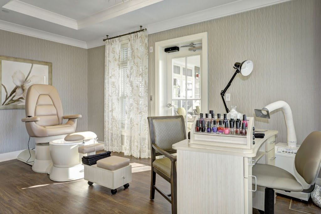 A cozy nail salon featuring a manicure and pedicure setup with neatly arranged nail polishes.