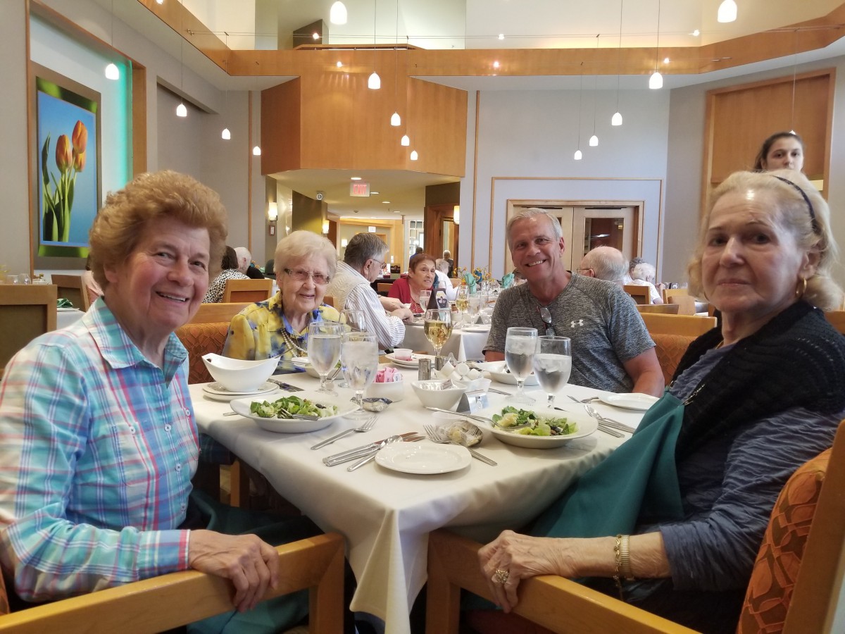 A group of people enjoying a meal together at a restaurant.