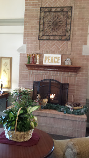 A warm and inviting living room featuring a beautifully decorated fireplace with a focus on peace.
