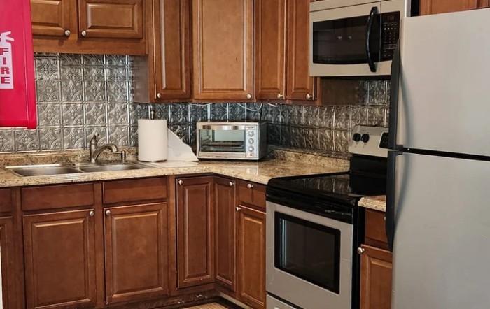 A modern kitchen featuring wooden cabinets and stainless steel appliances.