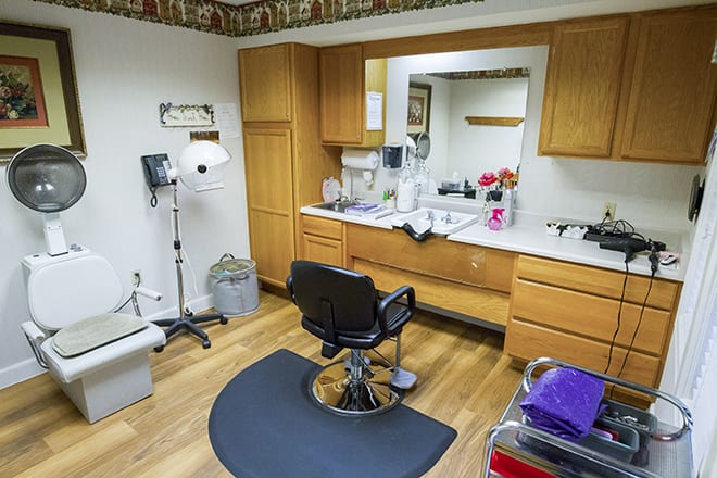 A medical examination room equipped with a chair and various medical instruments.