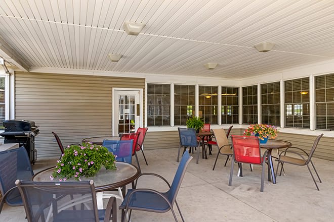 A cozy outdoor patio with colorful seating and plants, perfect for relaxation.