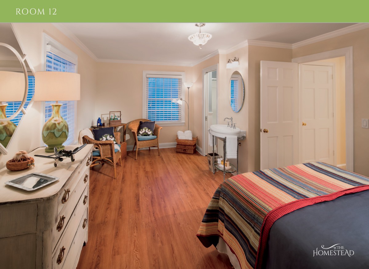 A well-decorated bedroom with modern furnishings and wooden flooring.