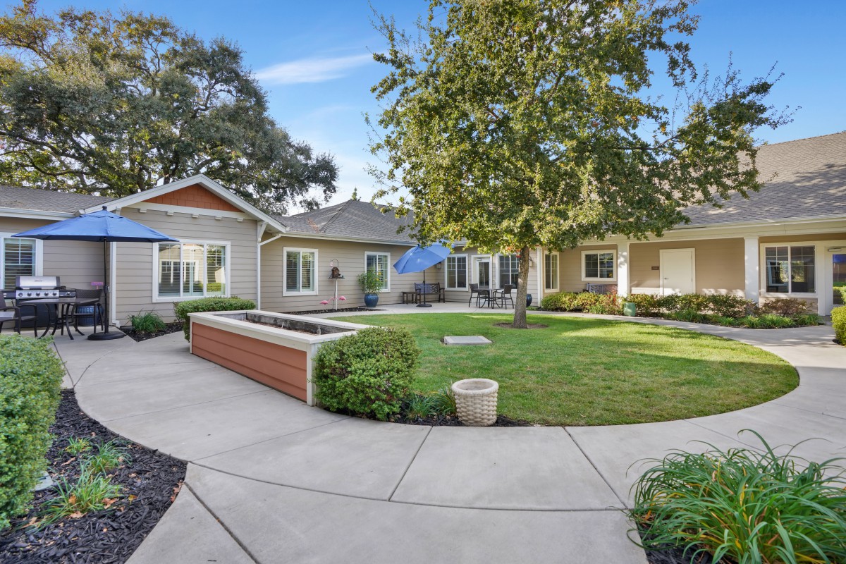 Beautiful suburban home with a well-maintained yard and patio area.