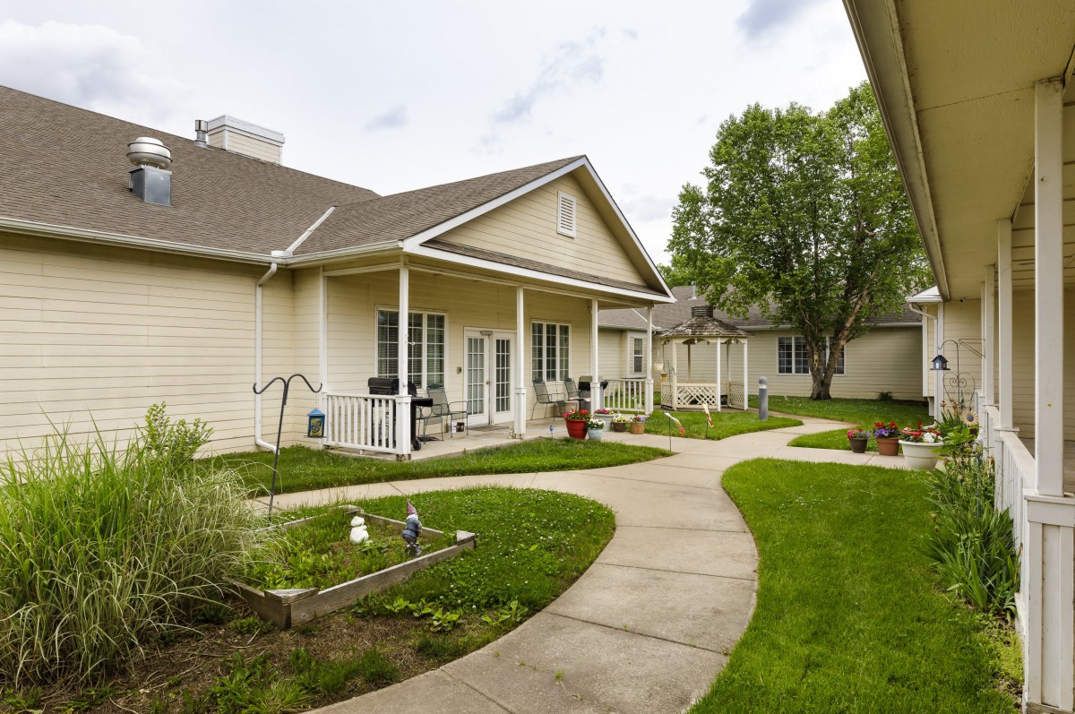 A serene residential home with a well-maintained yard and garden pathway.