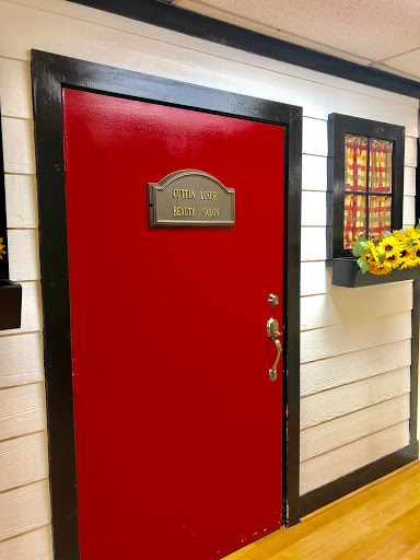A vibrant red door with decorative elements and a bright window.