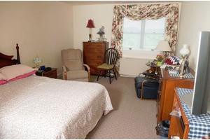 A cozy bedroom with classic decor and comfortable furniture.