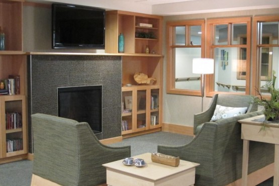A cozy living room with comfortable seating, a fireplace, and a television.