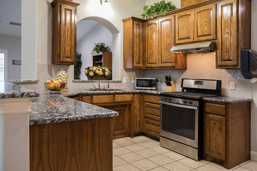 A warm and inviting kitchen featuring wooden cabinetry and modern appliances.