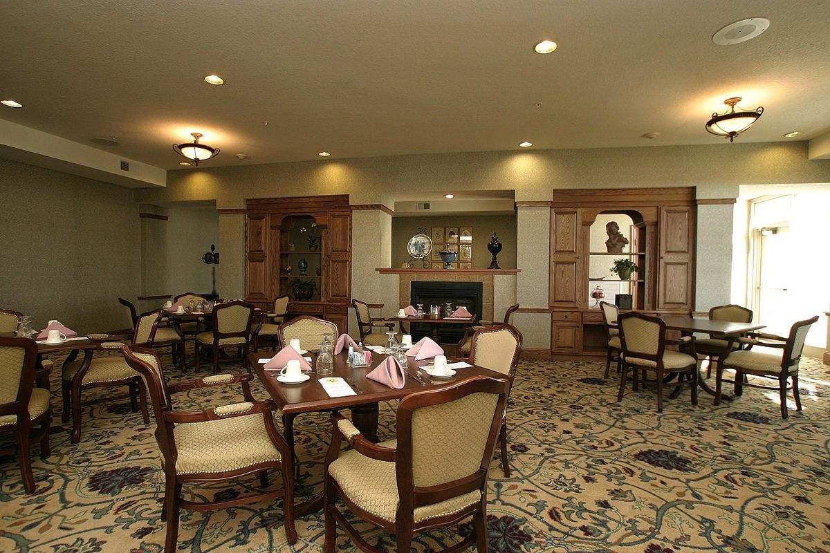 A cozy dining room with elegant furniture and warm lighting.