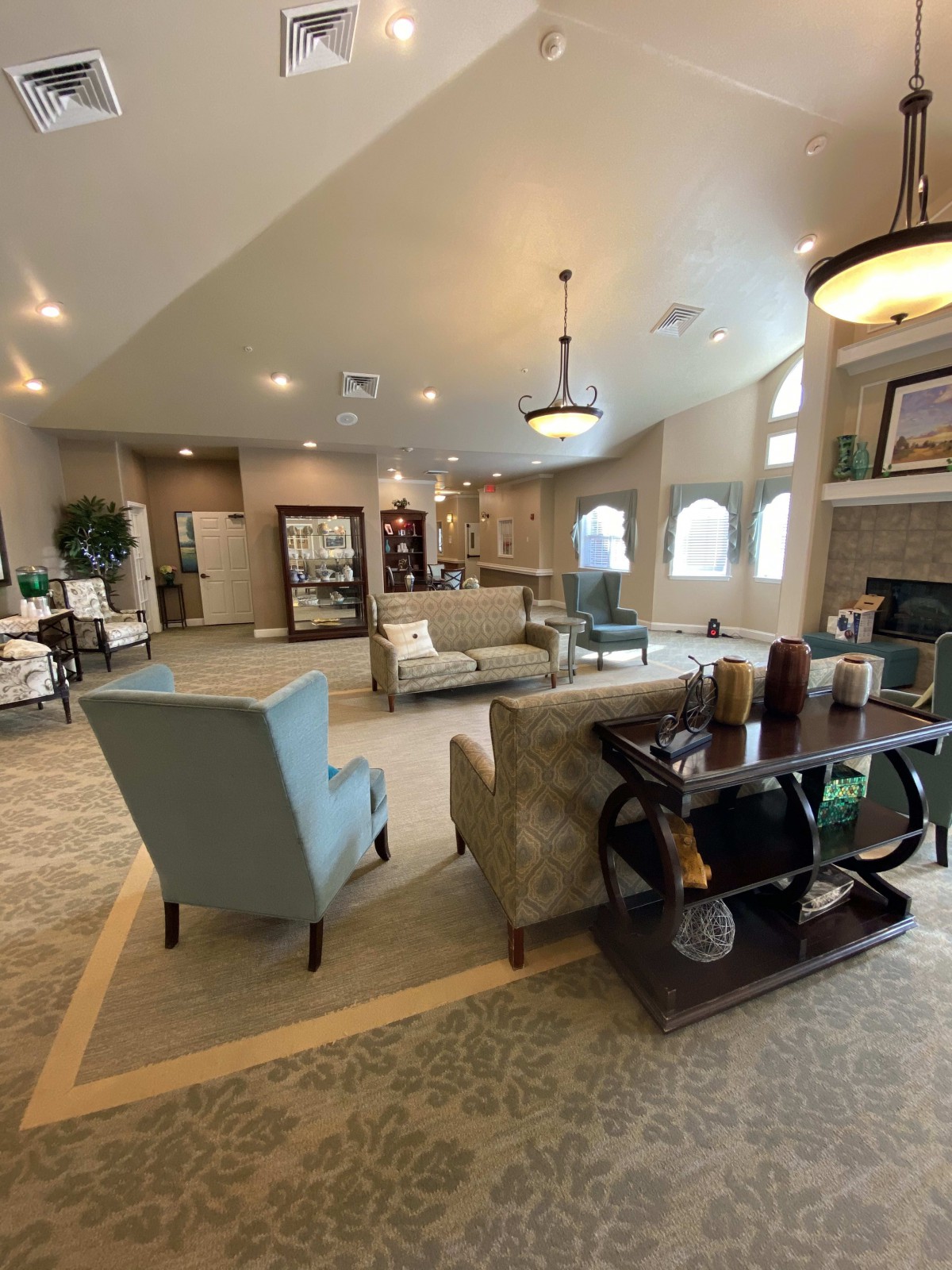 A spacious and modern living room with stylish furniture and ample lighting.