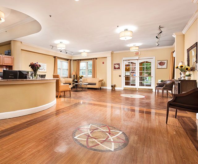 A modern lobby with wood flooring, comfortable seating, and stylish lighting.