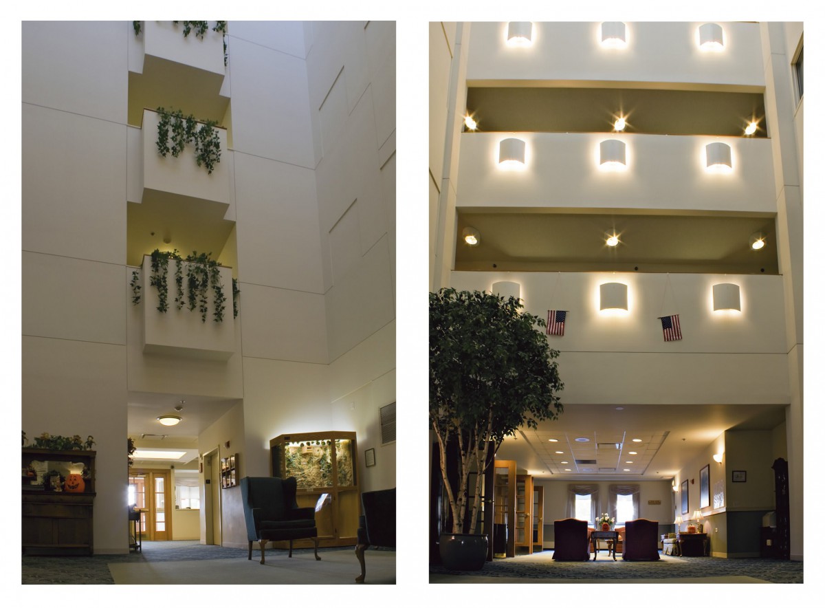 A spacious hotel lobby features an atrium with multiple balconies, decorative plants, and warm lighting.