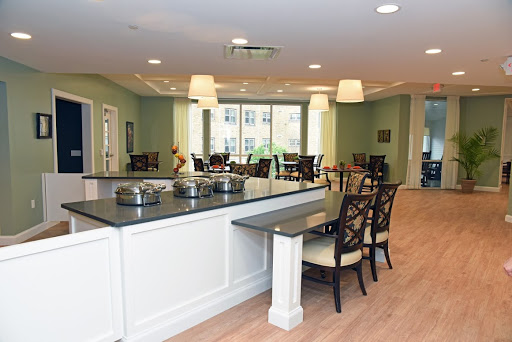 A modern dining area featuring comfortable seating and ample natural light.
