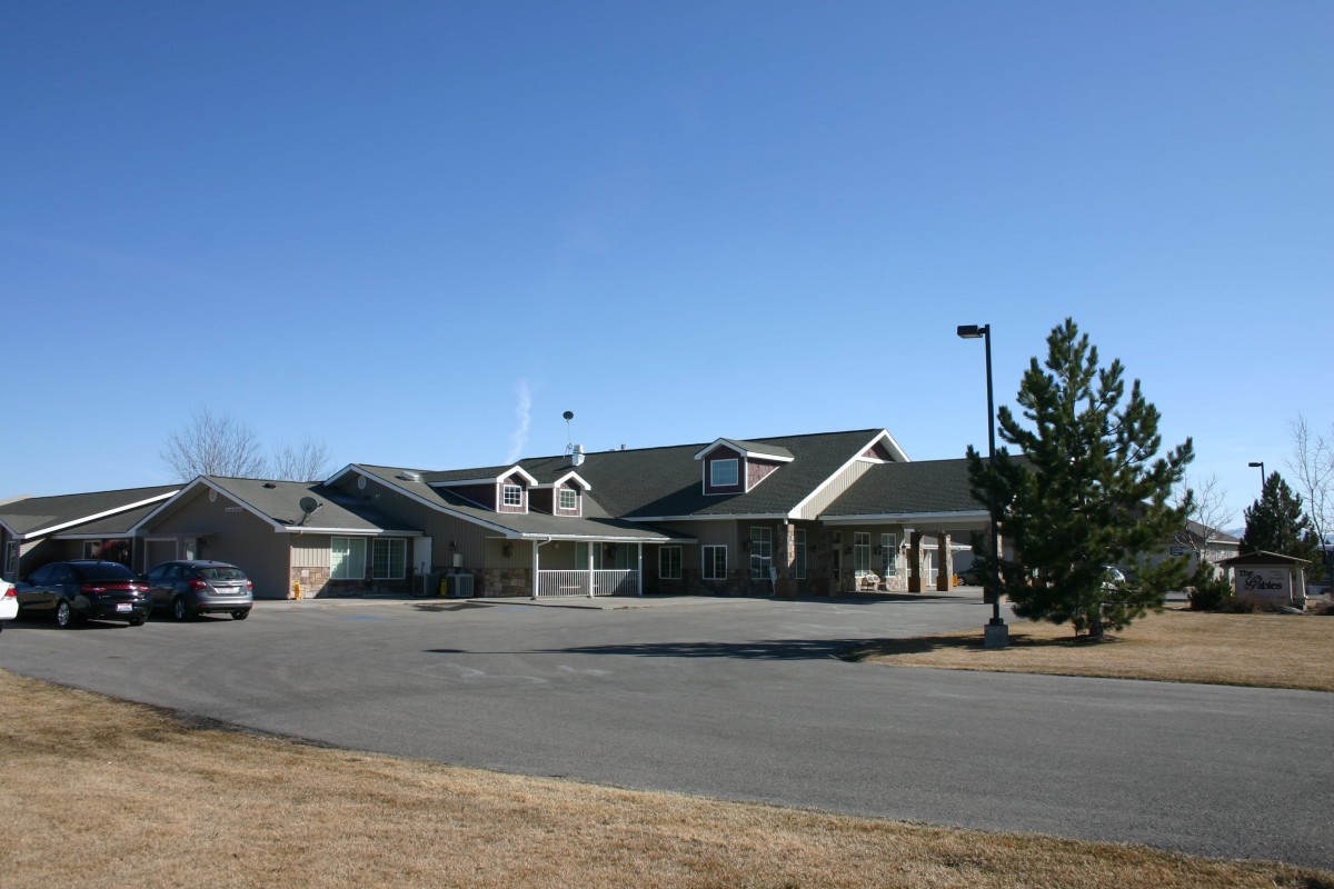 A suburban house with a driveway and clear blue sky.