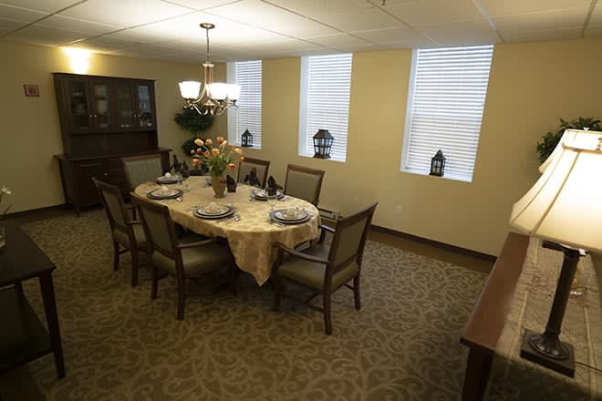 A well-decorated dining room with a set table and elegant lighting.