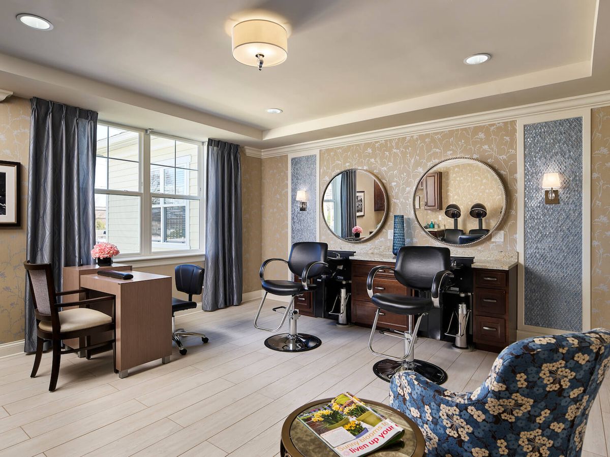 A stylish salon interior with mirrors and seating arrangements.