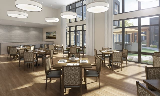 A modern dining area with elegant tables and chairs, featuring large windows and stylish lighting.