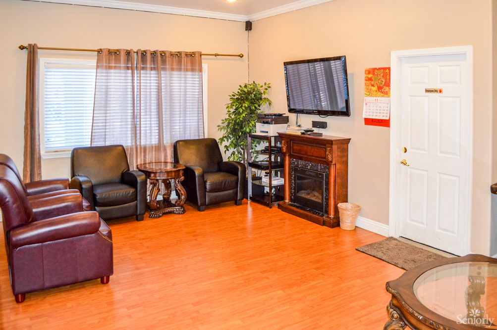 Cozy living room with a fireplace, television, and comfortable seating.