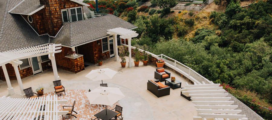 Spacious outdoor patio with furniture and a scenic view.