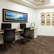 A modern office space with computers and stylish artwork on the walls.