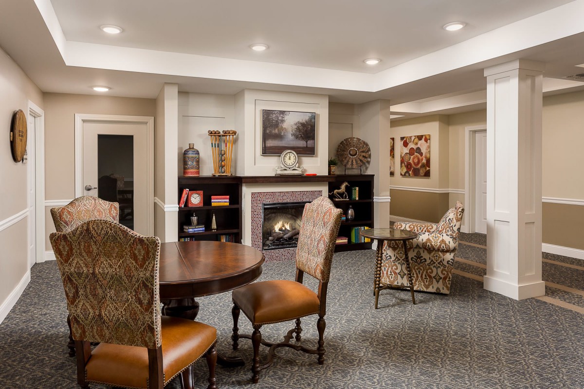 A cozy living room with a fireplace, elegant furniture, and tasteful decor.