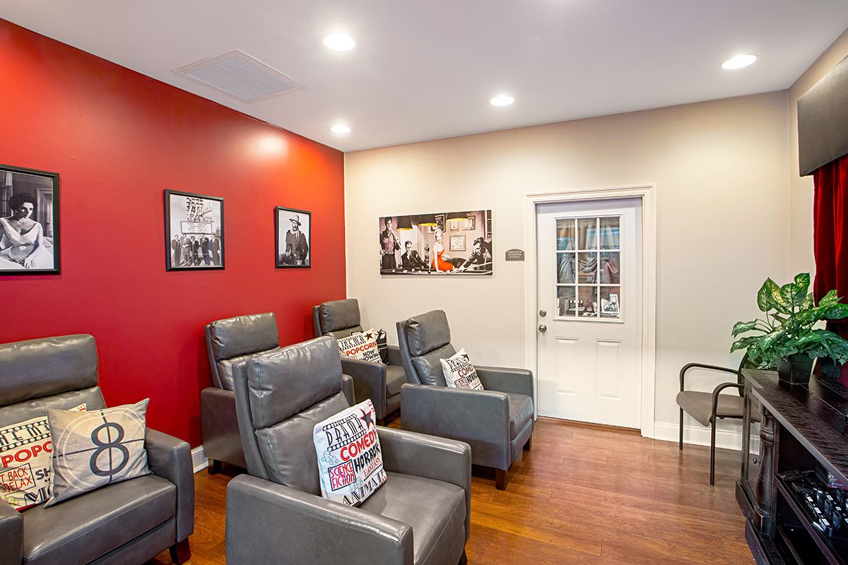 A modern interior space with comfortable chairs and a striking red accent wall.
