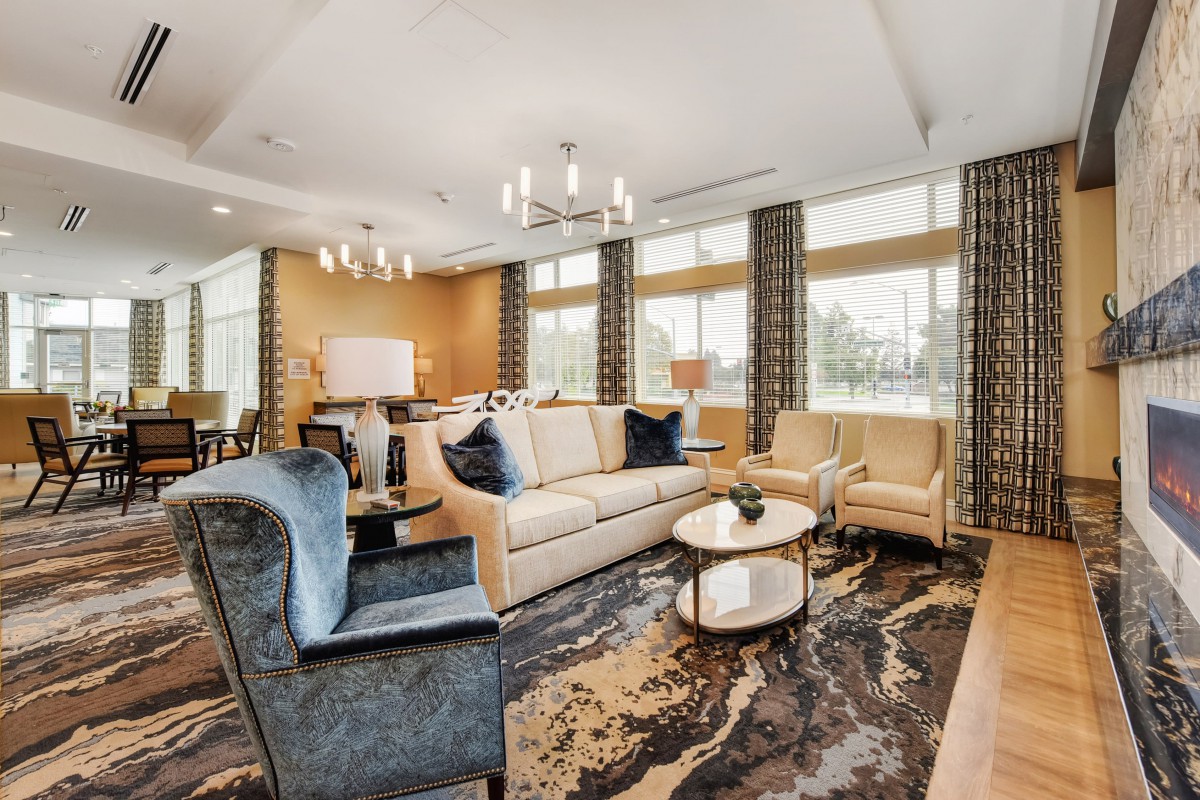 A beautifully designed living room with elegant furniture and large windows.