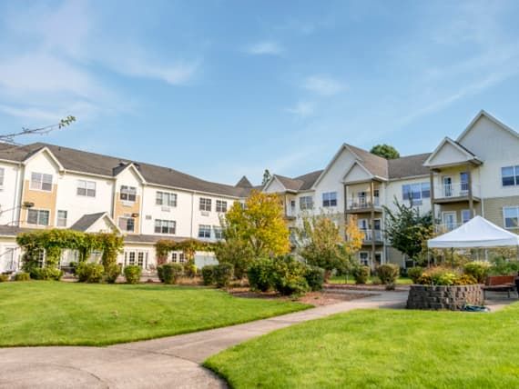 A residential building with a well-maintained garden and pathway.