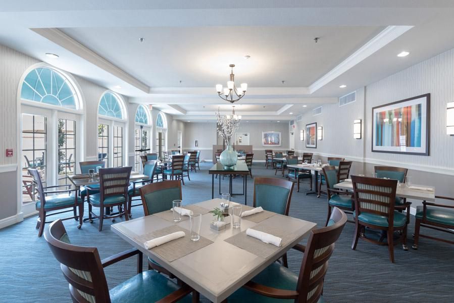Elegant dining room with neatly arranged tables and chairs.