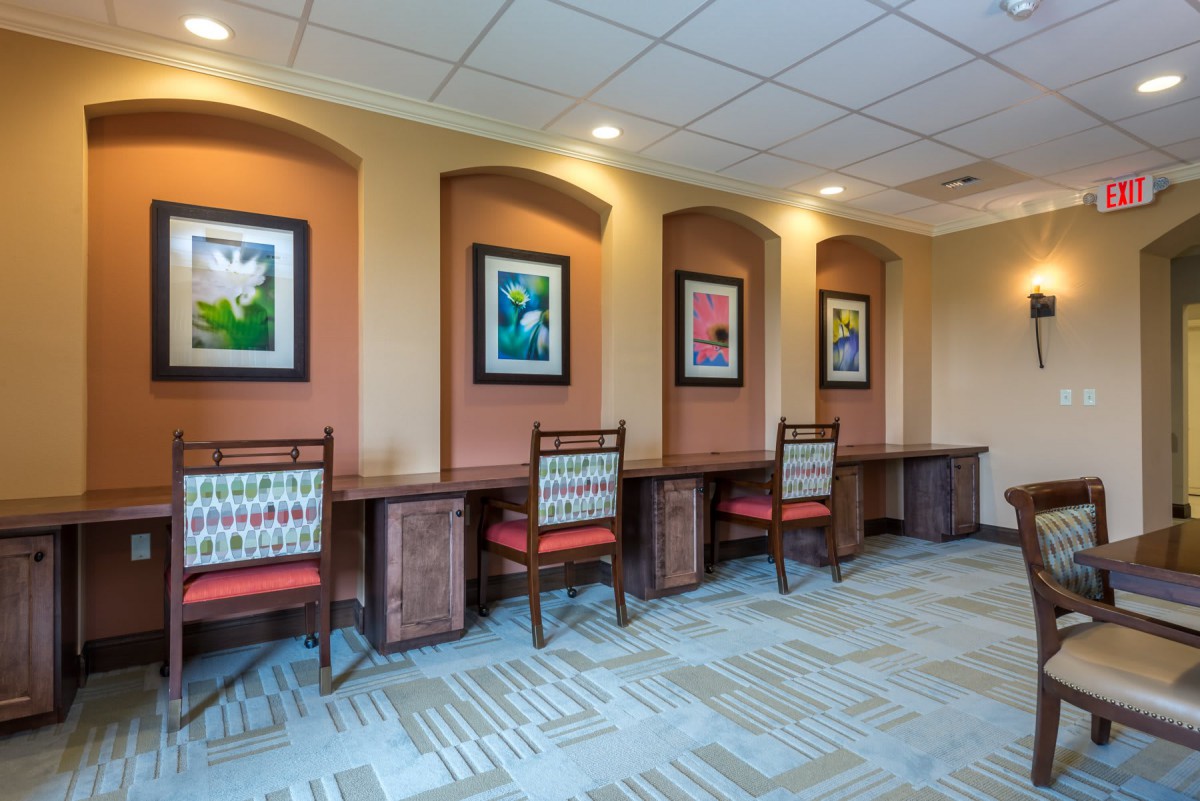 A well-lit office area with desks and colorful artwork on the walls.