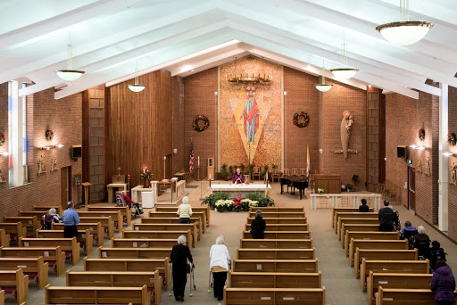 A serene view of the interior of a church, highlighting the altar and wooden pews.