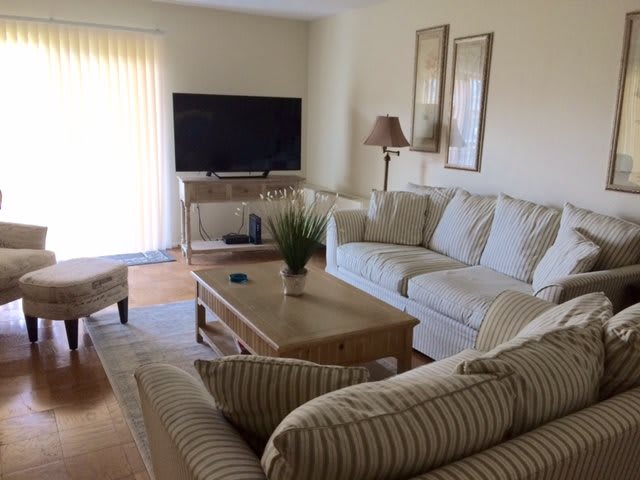A cozy living room with a comfortable sofa, coffee table, and television.