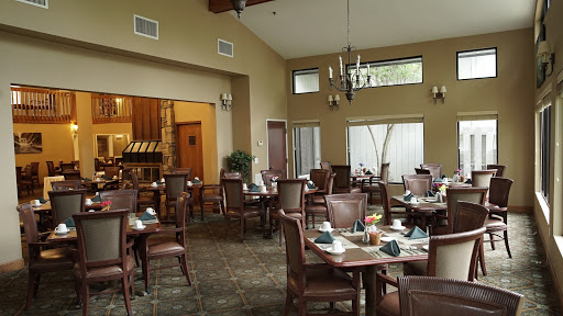 A cozy dining area featuring elegant furniture and warm lighting.