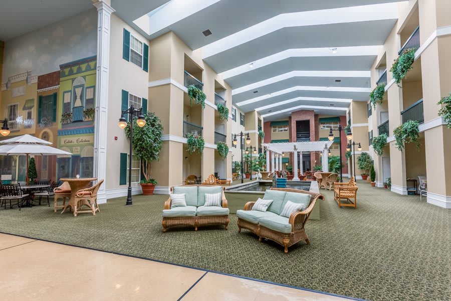 A spacious and well-lit atrium with comfortable seating and indoor plants.