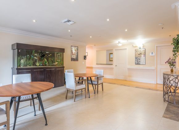 A modern dining area with wooden tables and stylish chairs, well-lit with ambient lighting.