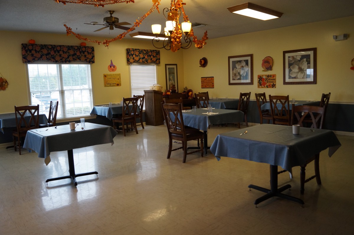 An empty dining room with decorated tables and chairs.