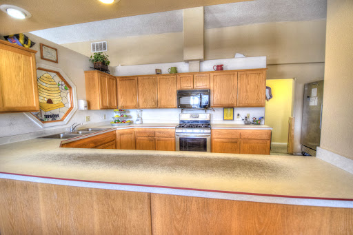 A spacious and modern kitchen featuring wooden cabinets and sleek appliances.