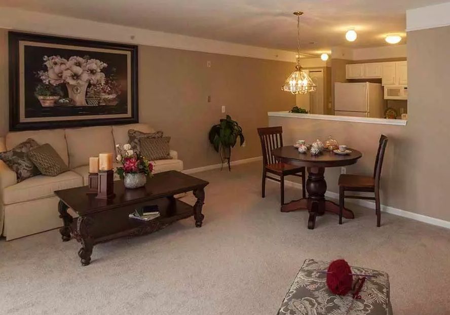 A cozy living and dining area with elegant furniture and warm lighting.