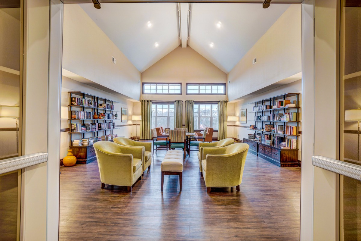 A cozy and spacious reading room with bookshelves and comfortable chairs.