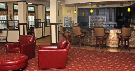 A cozy lobby area with leather seating and a small bar counter.