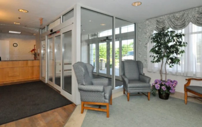 A welcoming lobby with comfortable chairs and glass doors.