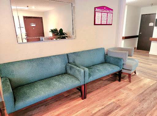 A comfortable waiting area featuring a blue sofa and armchair.