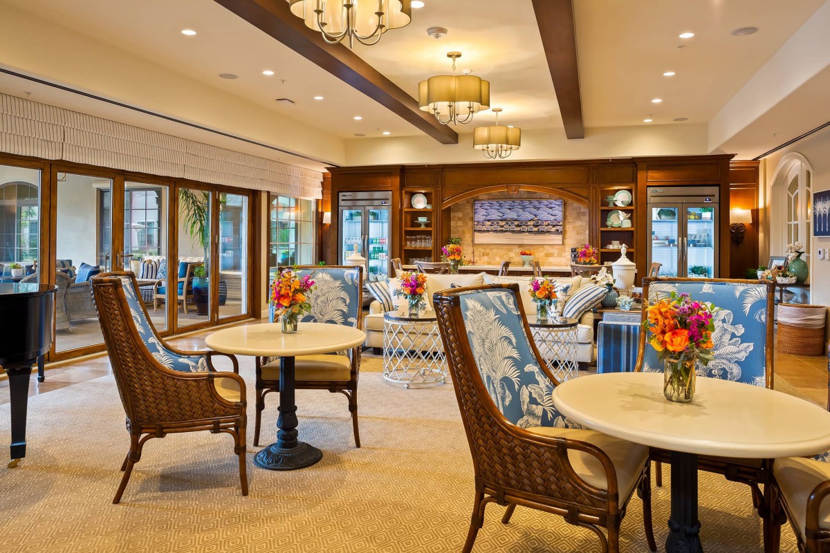 A cozy and well-decorated living area featuring comfortable seating, tables, and ambient lighting.