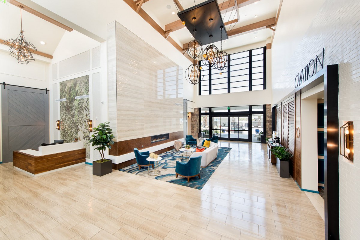 A bright and spacious modern lobby featuring stylish furniture and large windows.