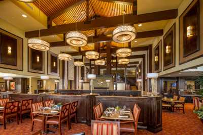 A stylish restaurant interior featuring elegant lighting and comfortable seating.