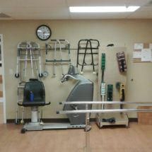 A physical therapy room equipped with various rehabilitation tools and exercise equipment.