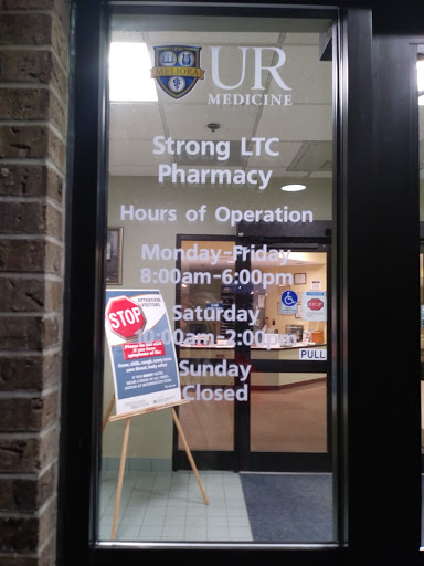 Signage displaying the hours of operation for Strong LTC Pharmacy.