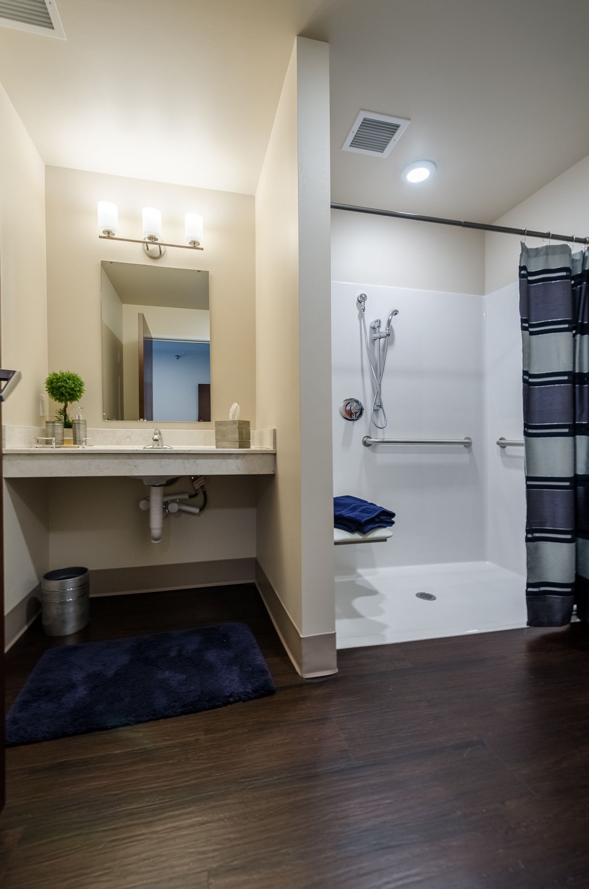 A modern and clean bathroom with a walk-in shower and sleek vanity.