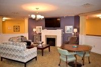 A cozy living room with a fireplace, television, and comfortable seating.